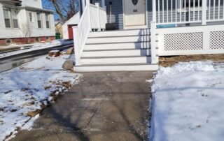 Cleared front walkway after professional snow removal at residential home