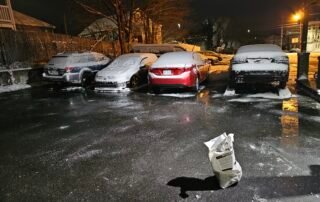 Salt applied on icy parking lot for safe vehicle and pedestrian access