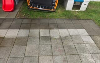 Outdoor patio with concrete pavers showing before and after cleaning results