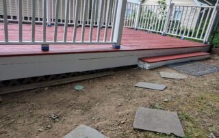 Newly painted red deck with white trim and railings after restoration