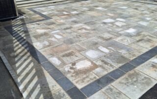 Newly installed stone patio with decorative dark border accent